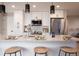 Modern kitchen featuring white cabinets, stainless steel appliances, and a large island with bar seating at 4341 N Columbine St, Denver, CO 80216