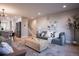 Open-concept living room with stylish decor, leading into the kitchen and dining area, plus a stairway at 4341 N Columbine St, Denver, CO 80216