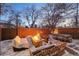 Cozy brick patio with fire pit, seating, and dining area, perfect for outdoor entertaining at 1433 E 7Th Ave, Denver, CO 80218