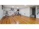 Finished basement with hardwood floors, built-in shelving, and home gym equipment at 1433 E 7Th Ave, Denver, CO 80218