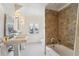 Spa-like bathroom with double sinks, a shower, and a brown tile surround at 1433 E 7Th Ave, Denver, CO 80218