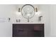 Stylish bathroom vanity with a round mirror and modern fixtures at 1433 E 7Th Ave, Denver, CO 80218