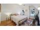 Charming bedroom with hardwood floors, a gold bed frame, and a cozy atmosphere at 1433 E 7Th Ave, Denver, CO 80218