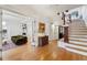 Bright entryway with hardwood floors, an elegant staircase, and views into the living room at 1433 E 7Th Ave, Denver, CO 80218