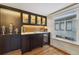 Modern wet bar with dark cabinetry, a wine cooler, and marble countertops at 1433 E 7Th Ave, Denver, CO 80218