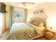 Cozy bedroom featuring a large window, hardwood floors and a modern ceiling fan at 2795 Se Grapevine Rd, Idledale, CO 80453