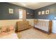 Bright Bedroom with a wooden crib, dresser, and toddler bed, complemented by natural light and a charming rug at 2795 Se Grapevine Rd, Idledale, CO 80453