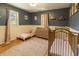 Cozy Bedroom featuring a wooden crib, dresser, and a white toddler bed, accented with soft colors and decor at 2795 Se Grapevine Rd, Idledale, CO 80453