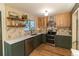 A charming kitchen featuring stainless steel appliances, stone walls, and open shelves at 2795 Se Grapevine Rd, Idledale, CO 80453