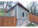 Corner view of small shed with cement block foundation and surrounding wooden fence at 2795 Se Grapevine Rd, Idledale, CO 80453