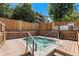 Outdoor hot tub surrounded by wood decking and a tall wooden fence at 4605 S Yosemite St # 401, Denver, CO 80237