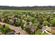 Aerial view of a serene neighborhood featuring well-maintained homes, mature trees, and a picturesque mountain backdrop at 8140 S Storm King Peak, Littleton, CO 80127