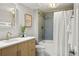 Well-lit bathroom with modern vanity, stylish fixtures, and tiled shower at 8140 S Storm King Peak, Littleton, CO 80127