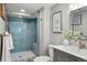 Stylish bathroom featuring a frameless shower with blue tiling and bronze fixtures at 8140 S Storm King Peak, Littleton, CO 80127