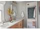 Bright bathroom with double sinks, modern fixtures, and access to a beautifully tiled shower area at 8140 S Storm King Peak, Littleton, CO 80127