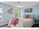 Inviting bedroom with hardwood floors, blue accent wall, and decorative wall art at 8140 S Storm King Peak, Littleton, CO 80127