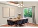 Dining room featuring a large wooden table, seating for eight, and plenty of natural light at 8140 S Storm King Peak, Littleton, CO 80127