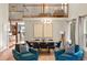 Open concept living room showcasing hardwood floors, large windows, and an upper level loft at 8140 S Storm King Peak, Littleton, CO 80127