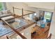 Open-concept loft area with a glass railing, hardwood floors, and a view of the living room below at 8140 S Storm King Peak, Littleton, CO 80127