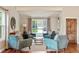 Inviting living room with vaulted ceilings, hardwood floors, comfortable seating, and natural light at 8140 S Storm King Peak, Littleton, CO 80127
