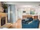 Bright living room showcases a cozy fireplace and opens into the kitchen with a modern chandelier at 8140 S Storm King Peak, Littleton, CO 80127