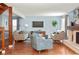 Sunlit living room boasts hardwood floors, modern decor, and a stylish fireplace, perfect for relaxation at 8140 S Storm King Peak, Littleton, CO 80127