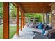Covered patio with wooden beams and comfortable seating, including hammocks and cushioned chairs at 8140 S Storm King Peak, Littleton, CO 80127