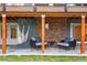 Covered patio featuring a cozy seating area with comfortable chairs and a hammock, creating a relaxing outdoor space at 8140 S Storm King Peak, Littleton, CO 80127