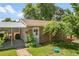 A well-maintained backyard featuring lush greenery, mature trees, and a detached brick garage at 4705 Upham St, Wheat Ridge, CO 80033