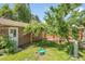 Lush backyard featuring mature trees and a garden area, offering a peaceful and private retreat at 4705 Upham St, Wheat Ridge, CO 80033