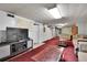 Basement den area with a TV, sofas, and a red rug at 4705 Upham St, Wheat Ridge, CO 80033