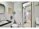 Bright bathroom with tiled walls and bathtub with shower at 4705 Upham St, Wheat Ridge, CO 80033
