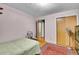 Bedroom features wood floors, area rug, and closet with wood sliding doors at 4705 Upham St, Wheat Ridge, CO 80033