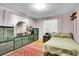 Bedroom with dark green accents and matching bed spread and furniture at 4705 Upham St, Wheat Ridge, CO 80033