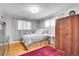 Bright bedroom with hardwood floors, natural light, wardrobe, and area rug at 4705 Upham St, Wheat Ridge, CO 80033