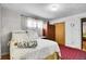 Comfortable bedroom with hardwood floors, natural light, wardrobe, and area rug at 4705 Upham St, Wheat Ridge, CO 80033
