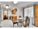 Dining room with table set next to window with bright natural light at 4705 Upham St, Wheat Ridge, CO 80033