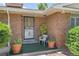 Inviting entrance with a secure screen door and potted plants for added curb appeal at 4705 Upham St, Wheat Ridge, CO 80033