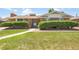 Charming brick home featuring a well-maintained lawn and mature landscaping at 4705 Upham St, Wheat Ridge, CO 80033