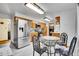 Kitchen with stainless steel appliances, wood cabinets, and a breakfast nook at 4705 Upham St, Wheat Ridge, CO 80033