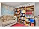 Living room area in finished basement with couches, world map, and bookshelves at 4705 Upham St, Wheat Ridge, CO 80033