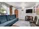 Comfortable sitting room with a stylish blue couch, complemented by a TV and elegant light fixture at 4705 Upham St, Wheat Ridge, CO 80033