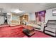 Finished basement living room with couches, area rug, and bookshelves at 4705 Upham St, Wheat Ridge, CO 80033