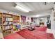 Finished basement living room with bookshelves, couches, fireplace, and area rug at 4705 Upham St, Wheat Ridge, CO 80033