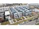A neighborhood showcases modern townhomes with white exteriors and gray roofs, lined neatly along the street at 1733 Irving St # 101, Denver, CO 80204