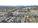 An aerial view captures a large neighborhood near Sloan's Lake with the Denver skyline in the distance at 1733 Irving St # 101, Denver, CO 80204