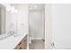 Modern bathroom with a wood vanity, quartz countertop, and stylish fixtures at 1733 Irving St # 101, Denver, CO 80204