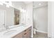 Elegant bathroom with double sinks, a large mirror, and modern lighting for a spa-like experience at 1733 Irving St # 101, Denver, CO 80204