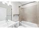 Clean bathroom featuring a bathtub and shower combination with modern fixtures and ample lighting at 1733 Irving St # 101, Denver, CO 80204
