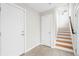 Bright entryway with tiled floors, white walls, and a staircase with wood treads at 1733 Irving St # 101, Denver, CO 80204